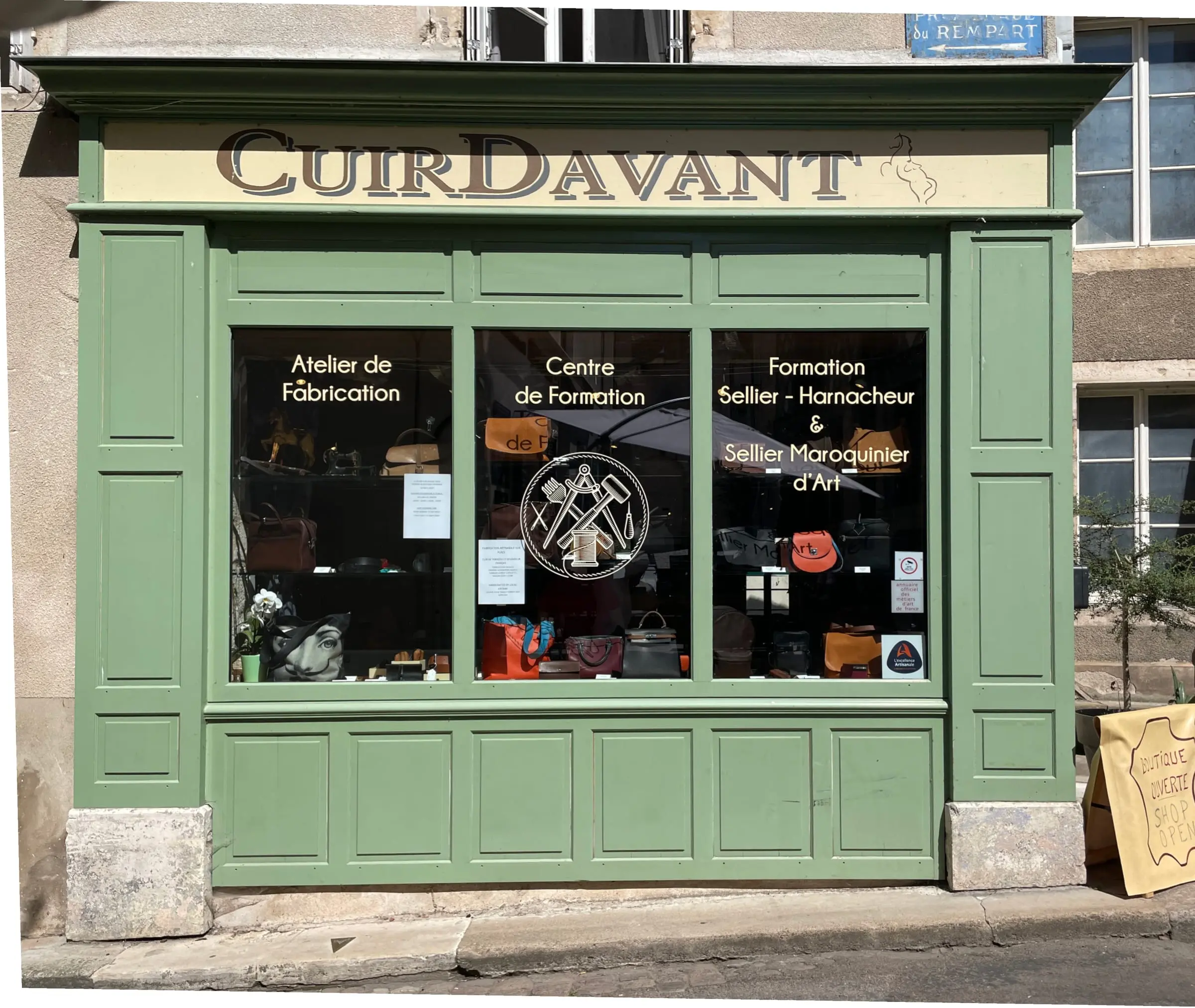 Green shopfront of the CuirDavant shop in Semur-en-Auxois — an artisan leather workshop and training centre for the leather crafts