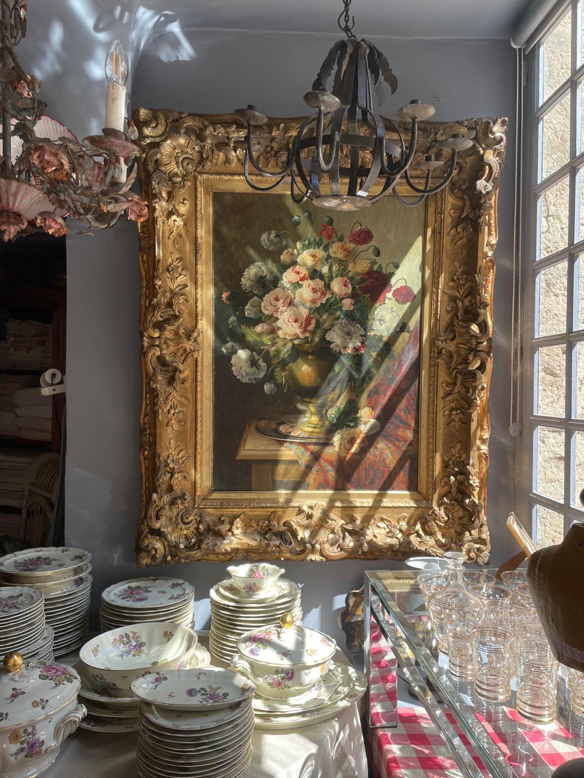 Antique painting in its gilded frame, old porcelain and glassware at Antiquaire porte de Semur, rue de la Liberté in Semur-en-Auxois