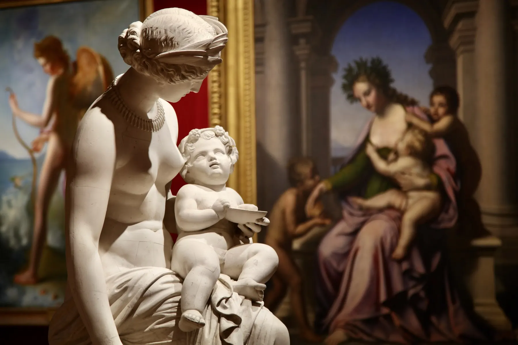 White marble sculpture in front of old paintings in a fine-arts room of the Museum of Semur-en-Auxois