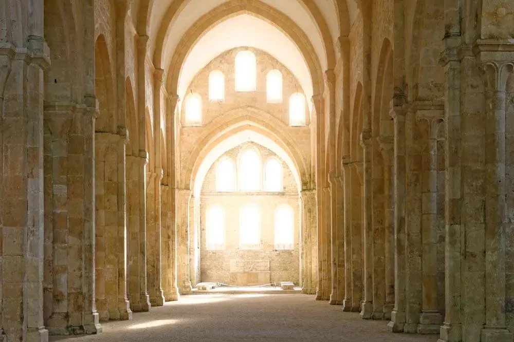 Exterior view of the abbey complex of Fontenay Abbey at the heart of its wooded valley