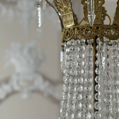 Detail of the crystal chandelier with pendants and brass mount